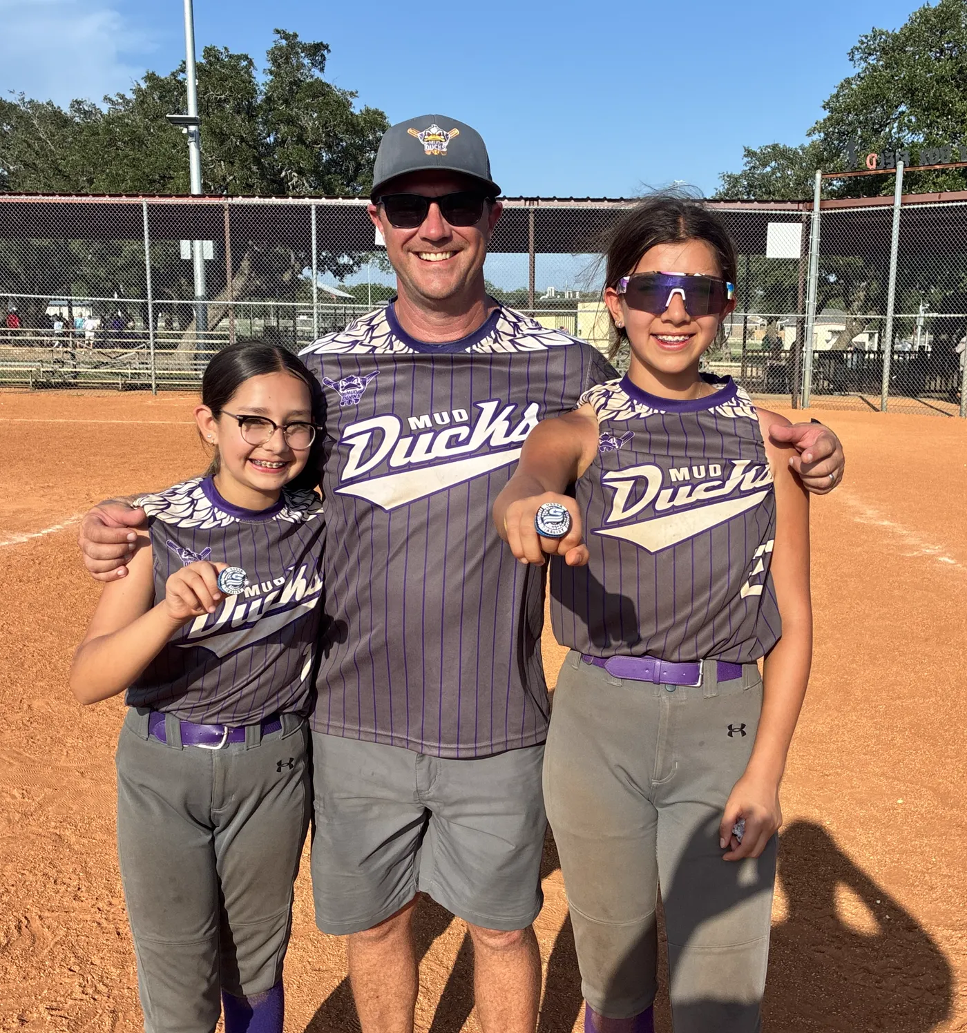 Michael Kidd with his daughters at a softball field
